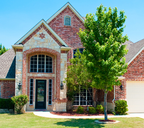 Front view of the house and a tree